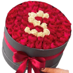 Round box filled with red and white roses arranged in a heart shape