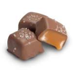 Three caramel-filled chocolates sprinkled with salt