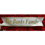 Red carnation arrangement with a gold-lettered family name banner
