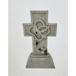 Decorative stone cross with small white roses and green leaves