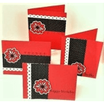 Stack of red and black birthday cards with floral accents