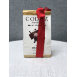 Gift bag of Godiva chocolates tied with a red ribbon