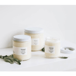 Three scented candles in glass jars on a white surface