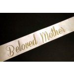 White ribbon printed with "Beloved Mother" in gold script