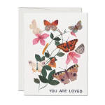 Greeting card with colorful butterflies around pink flowers and text You Are Loved.