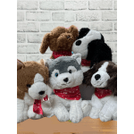 Five plush dog toys wearing red bandanas sit together.