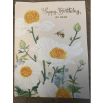 Birthday card with white flowers, a bee, and gold lettering