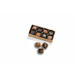 Box of assorted chocolates with three pieces outside the tray