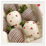 Box of chocolate-covered strawberries with heart decorations