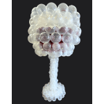 Clear balloon sculpture shaped like a tree on a black background