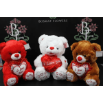 Three plush teddy bears holding heart decorations and "I Love You" signs