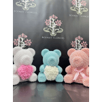 Three pearl-covered teddy bears with floral hearts in white, blue, and pink
