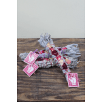 Bundle of dried flowers tied with pink string and tags