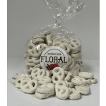 Bag of white pretzel-shaped snacks with a floral shop label