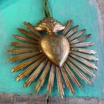 Gold heart-shaped wall ornament with radiating sunburst rays