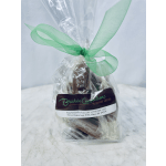 A wrapped gift bag tied with a green ribbon and labeled Bouchée Confections.