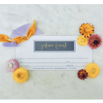 Gift card with small colorful flowers and ribbon on a marble surface