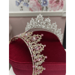 Two jeweled tiaras resting on a red velvet box