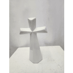 White ceramic cross-shaped memorial vase on a plain surface