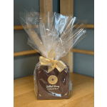 Wrapped box of salted honey caramels tied with a gold ribbon