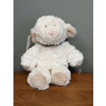Plush white teddy bear with beige ears and paws sitting on a chair
