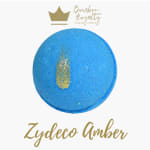 Blue round bath bomb with gold glitter accents