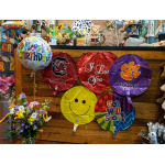 Birthday and get well balloons with a mixed flower bouquet in a vase