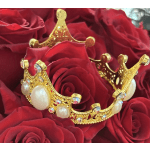 Red roses with a gold jeweled crown resting on top