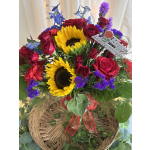 Basket arrangement with red roses, sunflowers, and purple flowers