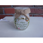 Decorative glass jar with a burlap bow and floral butterfly print