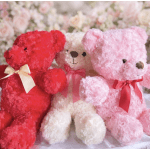 Three plush teddy bears in red, white, and pink with ribbons.