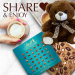 Teddy bear with chocolate boxes and a coffee cup on a white background