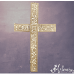 Decorative wooden cross with floral carvings on a purple background