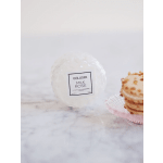 Wrapped white candle with a label reading Milk Rose