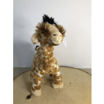 Plush giraffe toy standing on a round surface