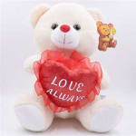 White teddy bear holding a red heart that says Love Always