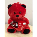 Red plush teddy bear holding a sequined heart with "I love you" text