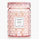 Pink faceted glass jar candle with white Voluspa Rose Otto label