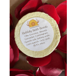 Round bath bomb surrounded by red rose petals