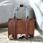Brown Wrangler tote bag with braided handles and cow-print trim