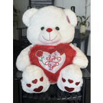 White teddy bear holding a red heart pillow with "Love You" text