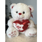 White teddy bear holding a red heart that says I Love You