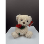 Plush teddy bear holding a red fabric rose