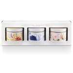 Boxed set of three floral patterned tin candles with white lids