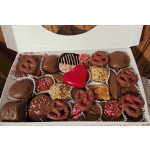 Box of assorted chocolate-covered candies with a red heart in the center