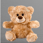 Plush teddy bear with tan fur and a smiling face on a gray background