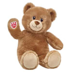 Brown teddy bear plush with a paw-print tag