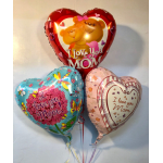 Three heart-shaped balloons with Mother's Day messages and teddy bears