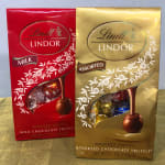 Two Lindt Lindor chocolate truffle boxes, one red and one gold
