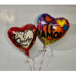Two heart-shaped balloons with Spanish love messages